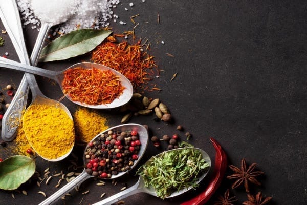 Colorful ingredients in spoons on slate