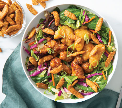 A crunchy asian chicken bowl with healthy greens, nutrient-packed chicken and flavorful toppings
