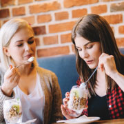 Two females eating appetizers